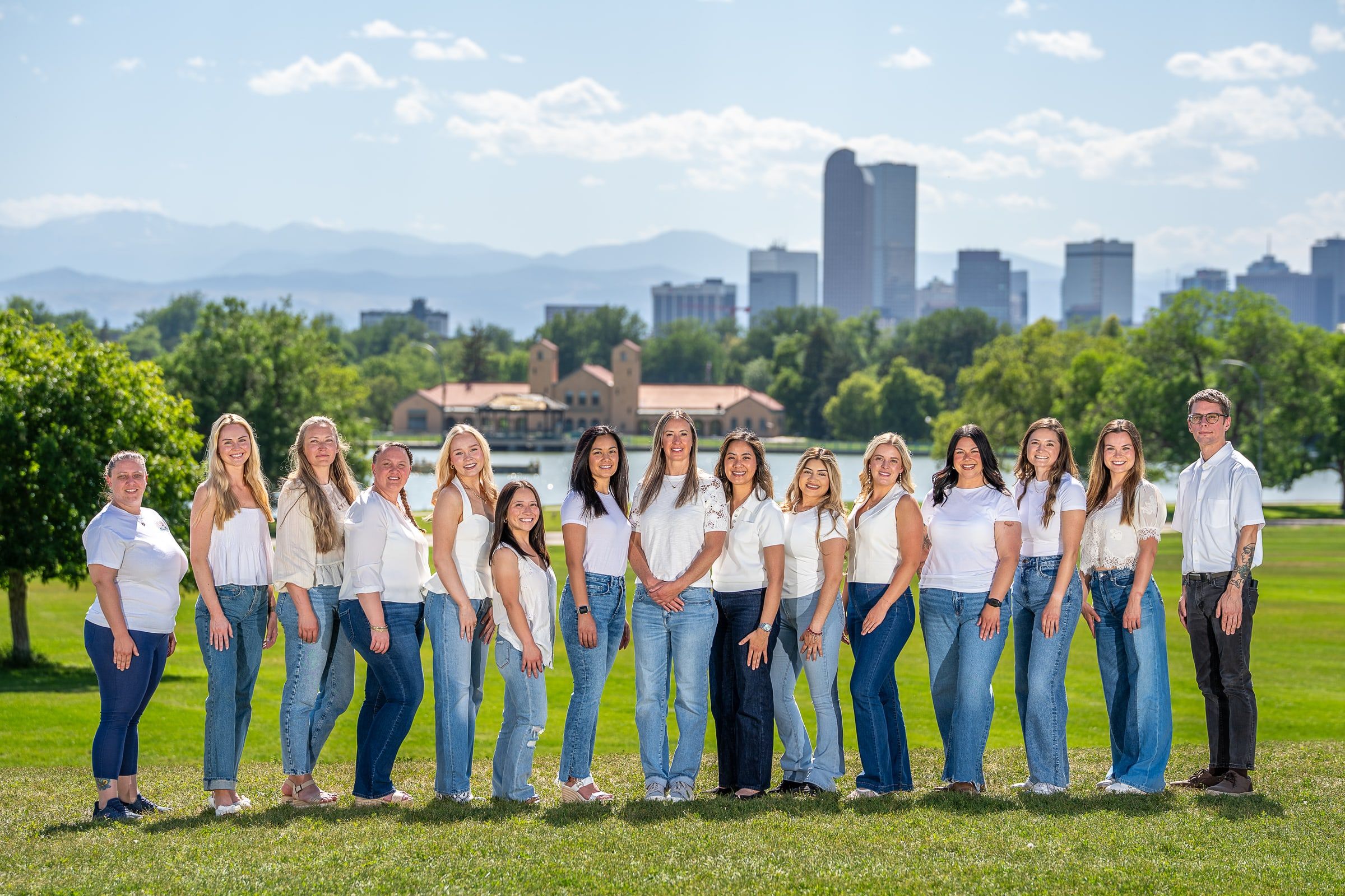 Cherry Creek Dental Spa team standing outdoors with the Denver skyline and mountains behind them